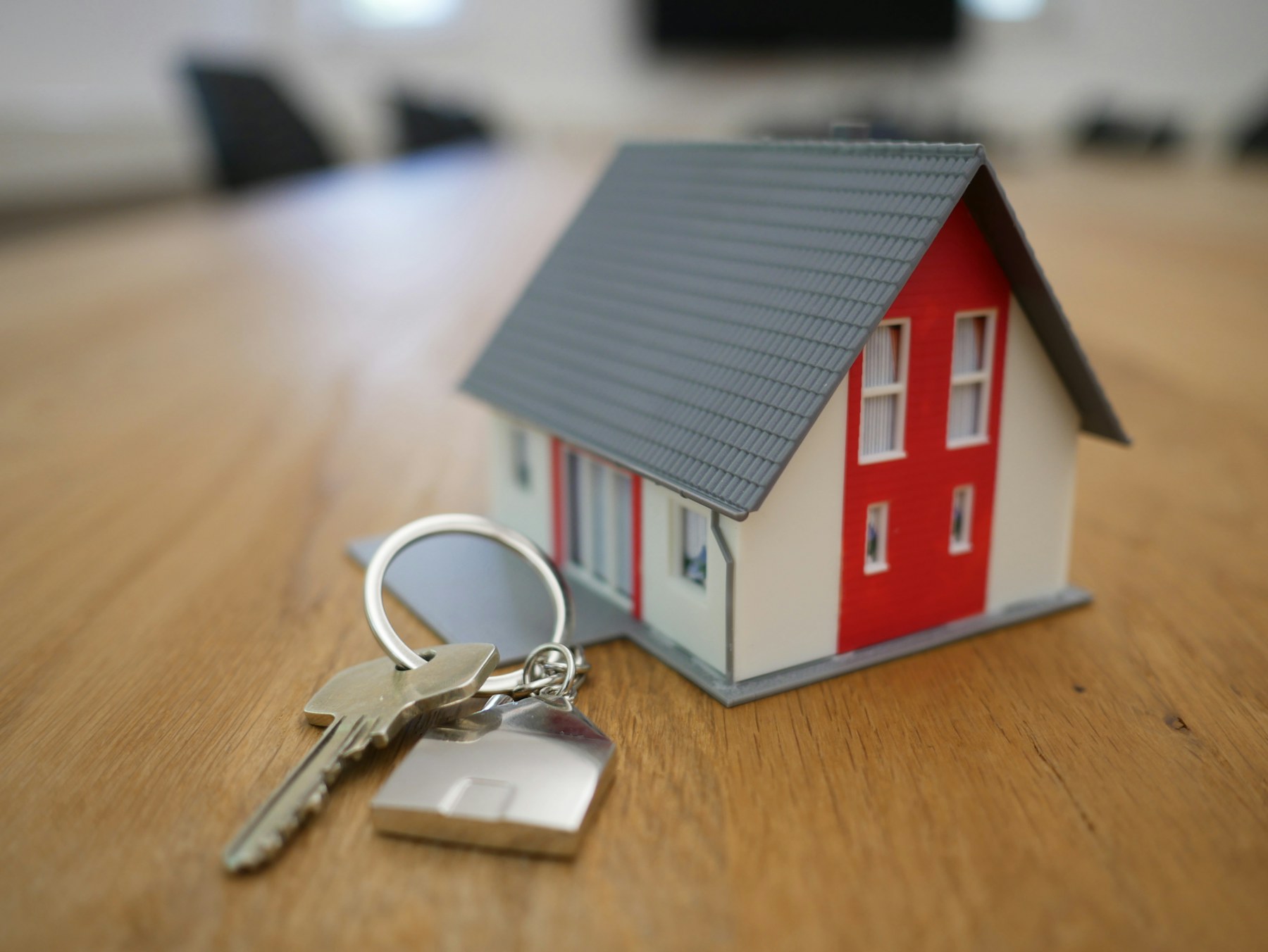House keys beside a residential property model